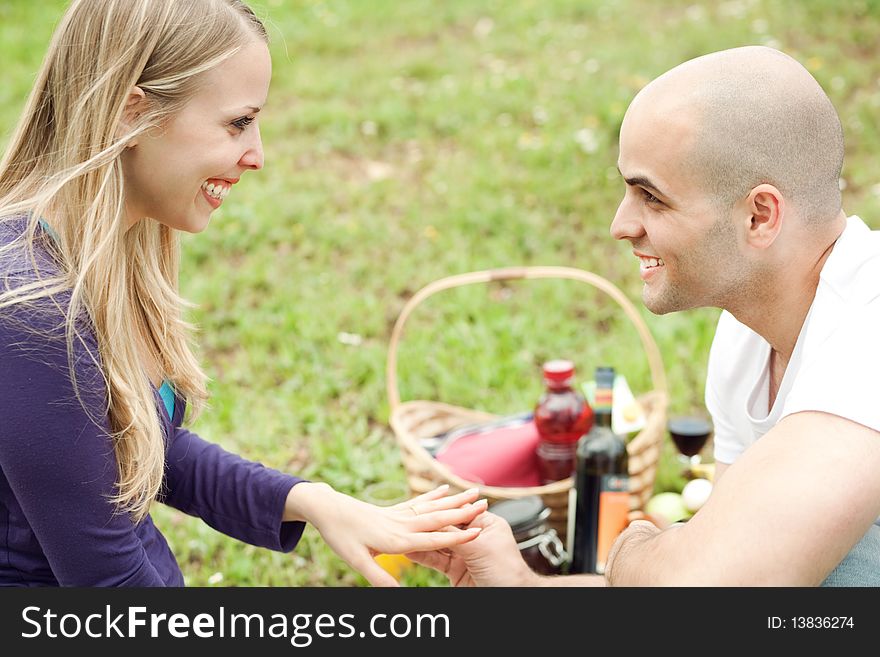 Woman very happy for the gift presented by her husband in the picnic