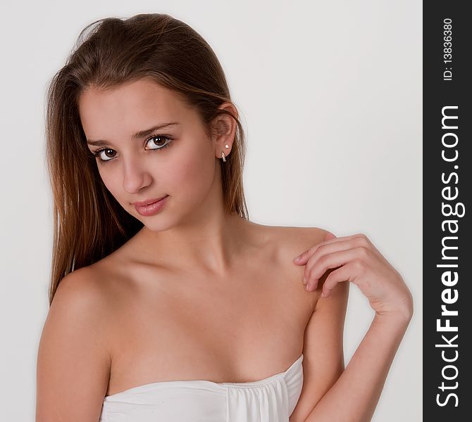 A soft, simple portrait of a pretty teenager in white. A soft, simple portrait of a pretty teenager in white