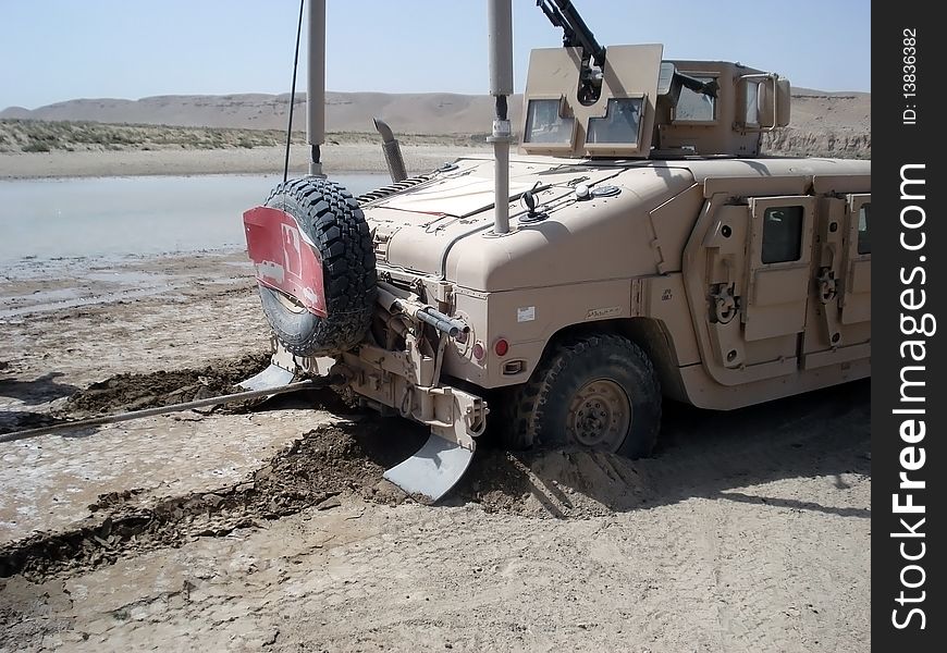 Big US Army Humvee got stuck in the sand at a training mission. Big US Army Humvee got stuck in the sand at a training mission