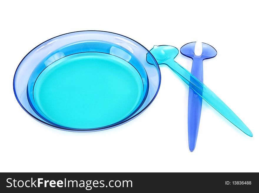 Blue plastic dishes, spoon, fork on white background