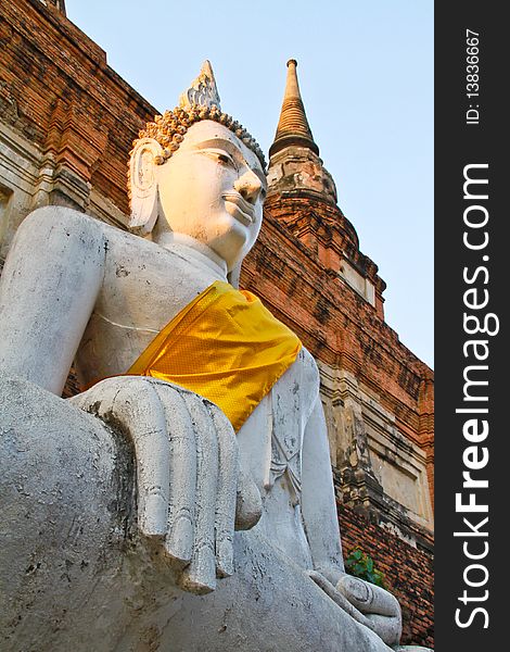 The ancient Buddha statue in front of the pagoda, Ayutthaya, Thailand. The ancient Buddha statue in front of the pagoda, Ayutthaya, Thailand