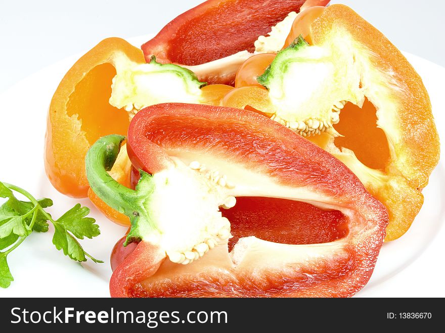 Red and yellow pepper halves on a white plate