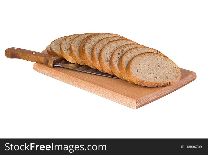 Bread and knife on wood cutting board. Bread and knife on wood cutting board