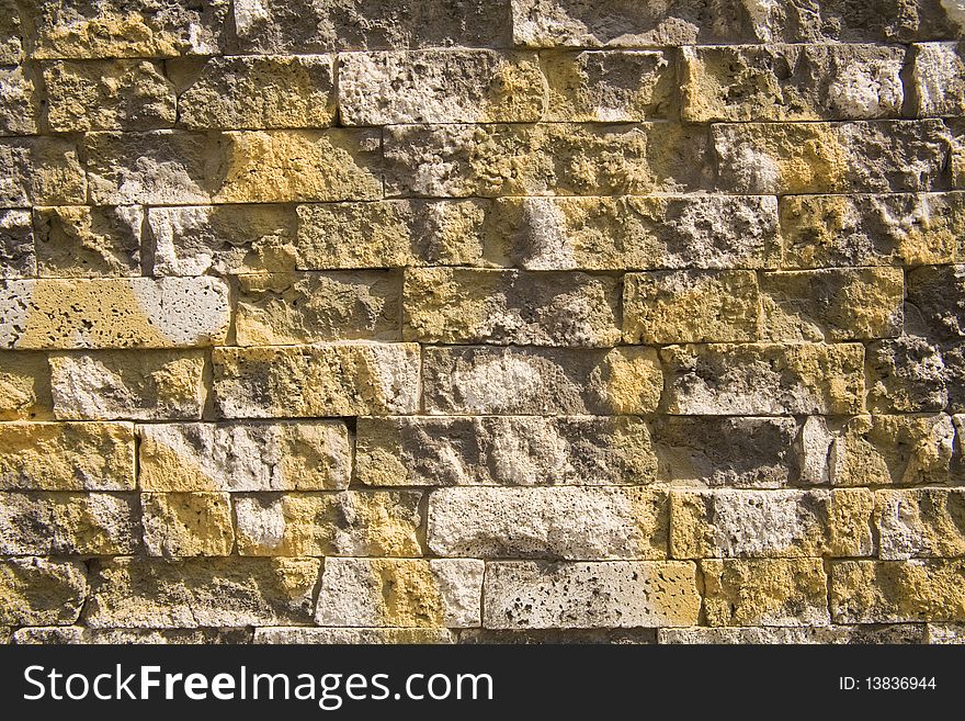 Detail of yellow graffiti over a brick wall. Detail of yellow graffiti over a brick wall.