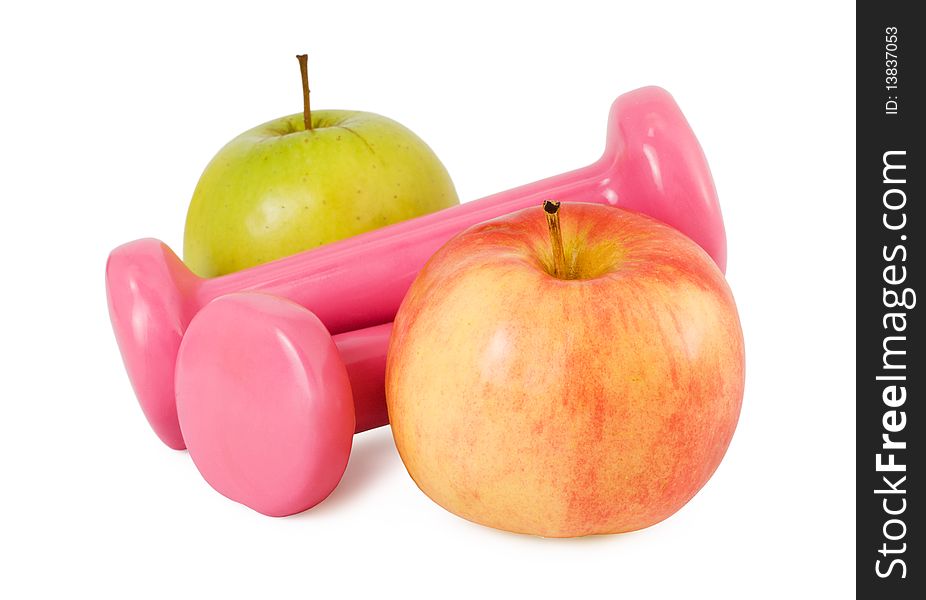 Two pink dumbbells and two apples on a white background. Two pink dumbbells and two apples on a white background