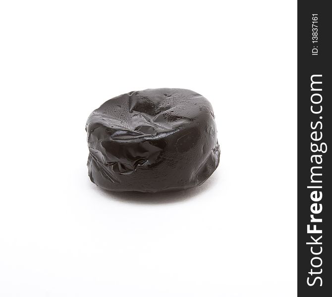 Black shiny Liquorice Toffee isolated against white background. Black shiny Liquorice Toffee isolated against white background.