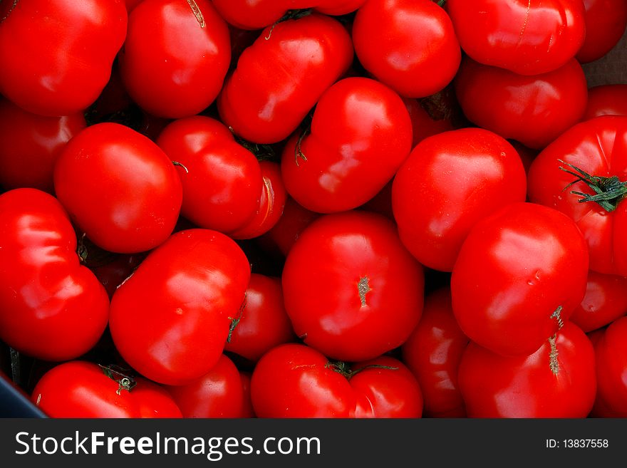 Many red tomatoes arranged at the market