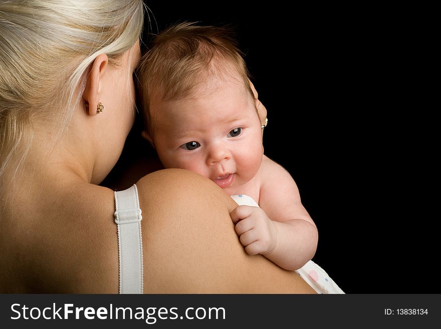 Infant smiling on the mother shoulder. Infant smiling on the mother shoulder