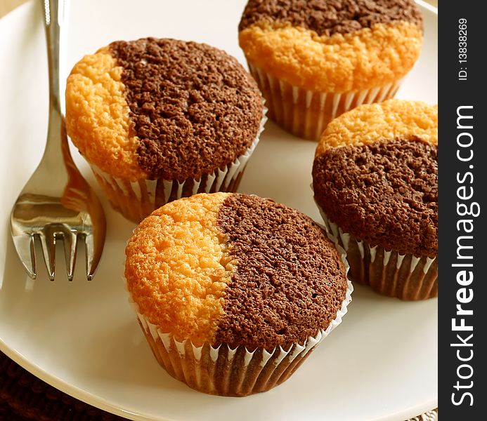 Chocolate cake on a white plate, breakfast. Chocolate cake on a white plate, breakfast