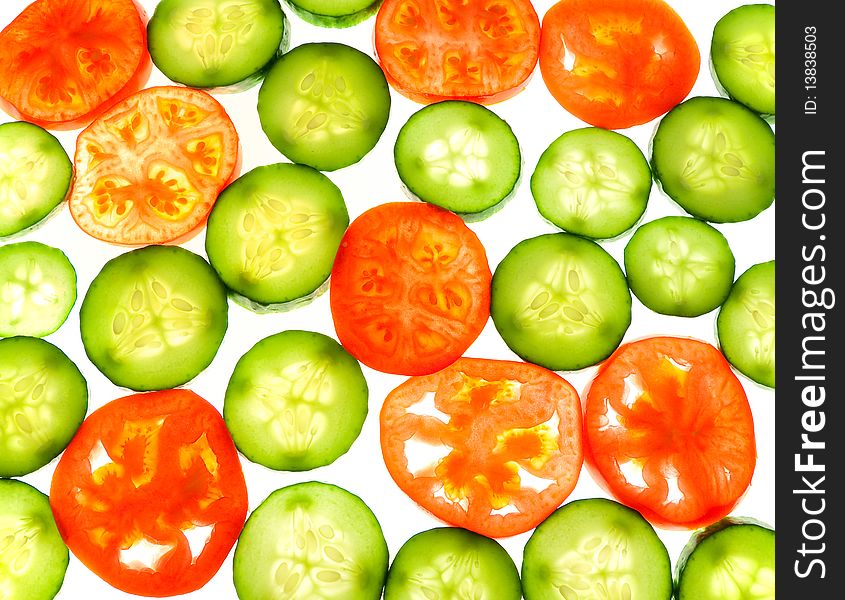 Tomatoes and cucumber - appetizing slices of vegetables