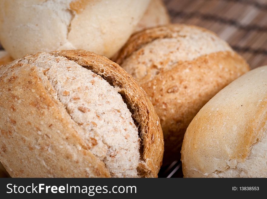 Rye and wheat french bread, baked in a wood oven. Selective focus. Extreme closeup. Rye and wheat french bread, baked in a wood oven. Selective focus. Extreme closeup.