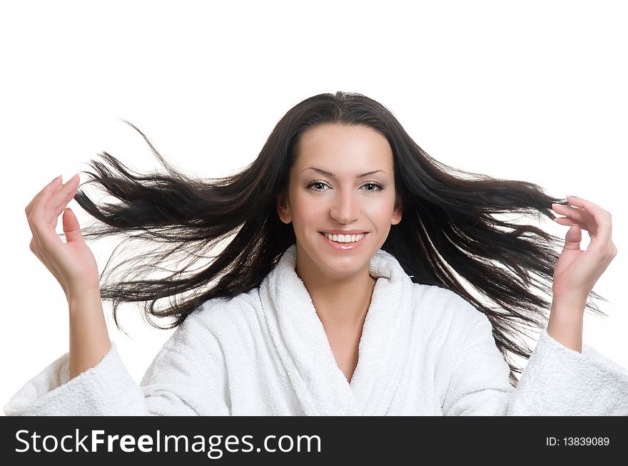 Smiling girl in bathrobe flinging long black hair. Smiling girl in bathrobe flinging long black hair.