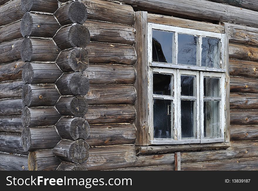 Fragment of old wooden house wall with window. Fragment of old wooden house wall with window