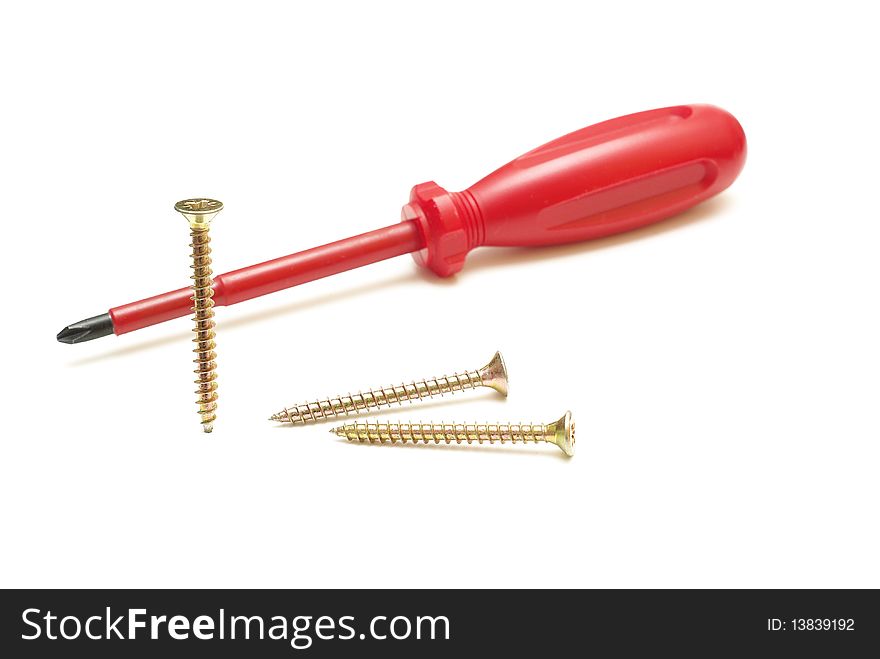 Red screwdriver and three screws. Red screwdriver and three screws