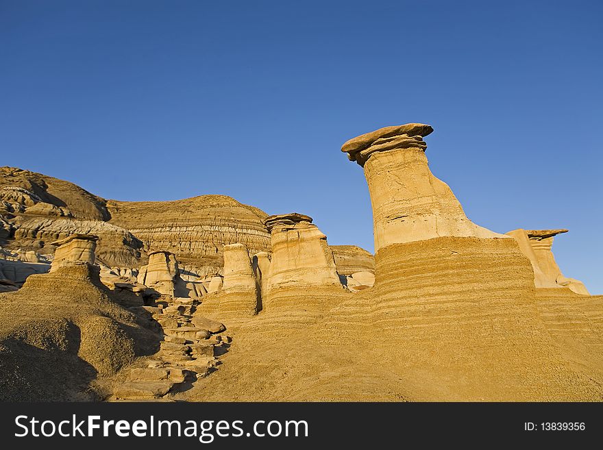 Group of sandstone hoodoos against the blue sky background located in Southern Alberta Canada. Group of sandstone hoodoos against the blue sky background located in Southern Alberta Canada
