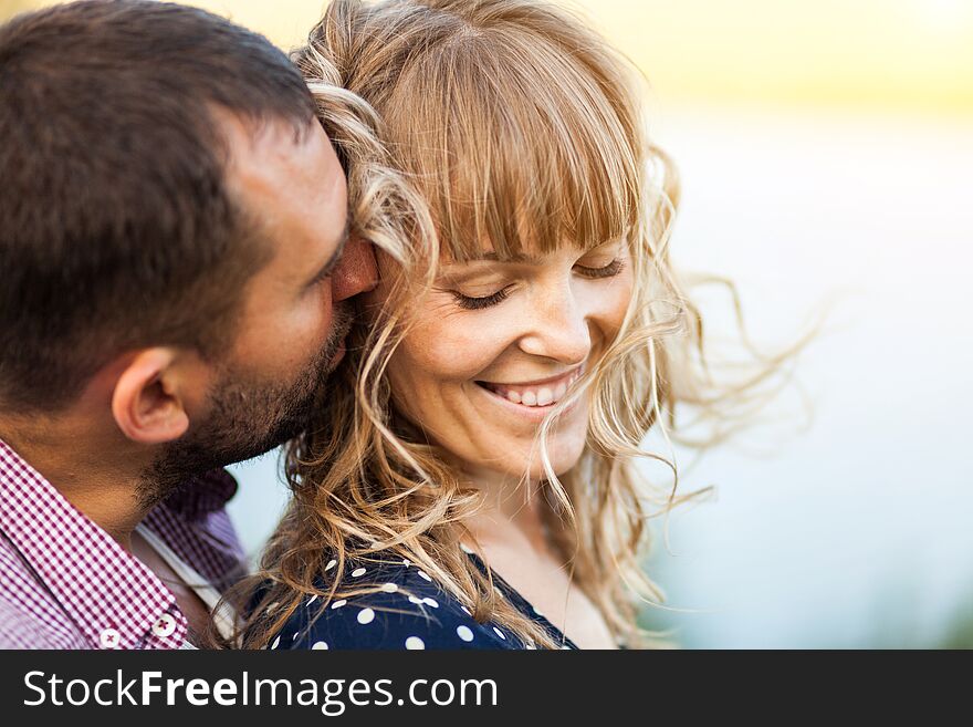 Close-up portrait of couple with wind in hair, hugging and happy together soft focus. Close-up portrait of couple with wind in hair, hugging and happy together soft focus