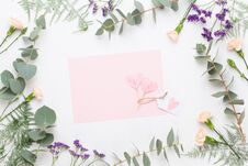 Flowers Composition. Paper Blank, Carnation Flowers, Eucalyptus Branches On Pastel Background. Flat Lay, Top View, Copy SpaceFlat Royalty Free Stock Photo Flowers Composition. Paper Blank, Carnation Flowers, Eucalyptus Branches On Pastel Background. Flat Lay, Top View, Copy SpaceFlat Royalty Free Stock Photo