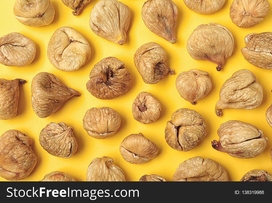 Flat lay composition with dried figs on color background. Healthy fruit