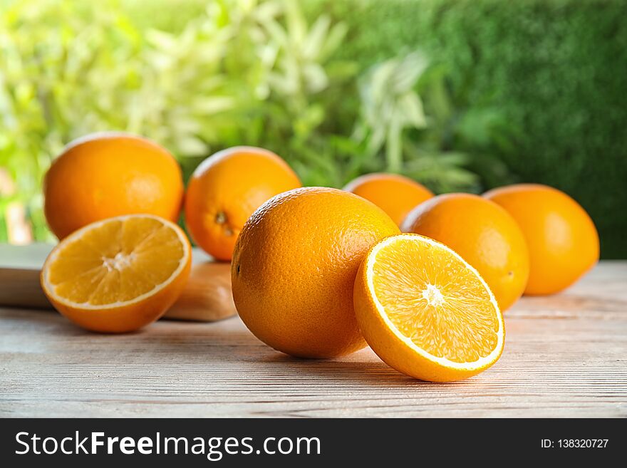 Fresh juicy oranges on wooden table