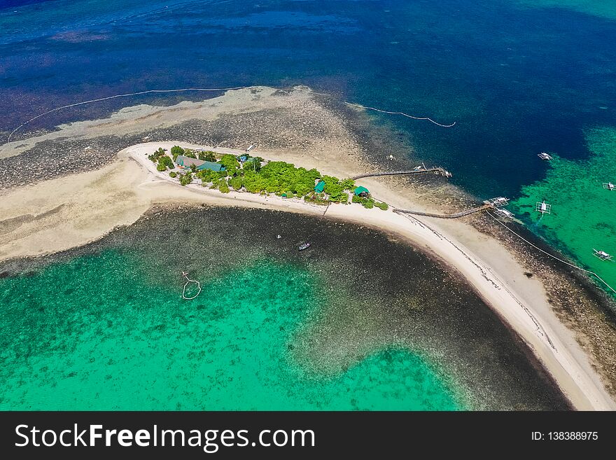 Tropical sea coast-Islands with white sand, local huts, palm trees. Aerial view from the drone