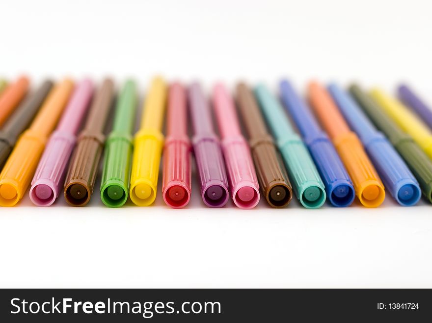 Front view of row of colorful markers with shallow dof