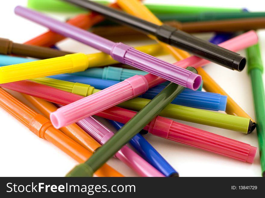 Pile of colorful markers on white background with shallow dof. Pile of colorful markers on white background with shallow dof