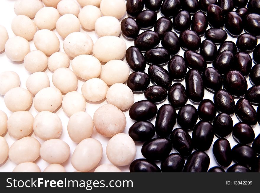 Nuts in black and white chocolate. White background. Nuts in black and white chocolate. White background