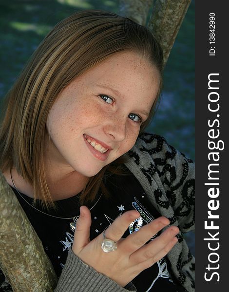 A beautiful white caucasian girl child with a happy expression on her face holding out her hand. A beautiful white caucasian girl child with a happy expression on her face holding out her hand