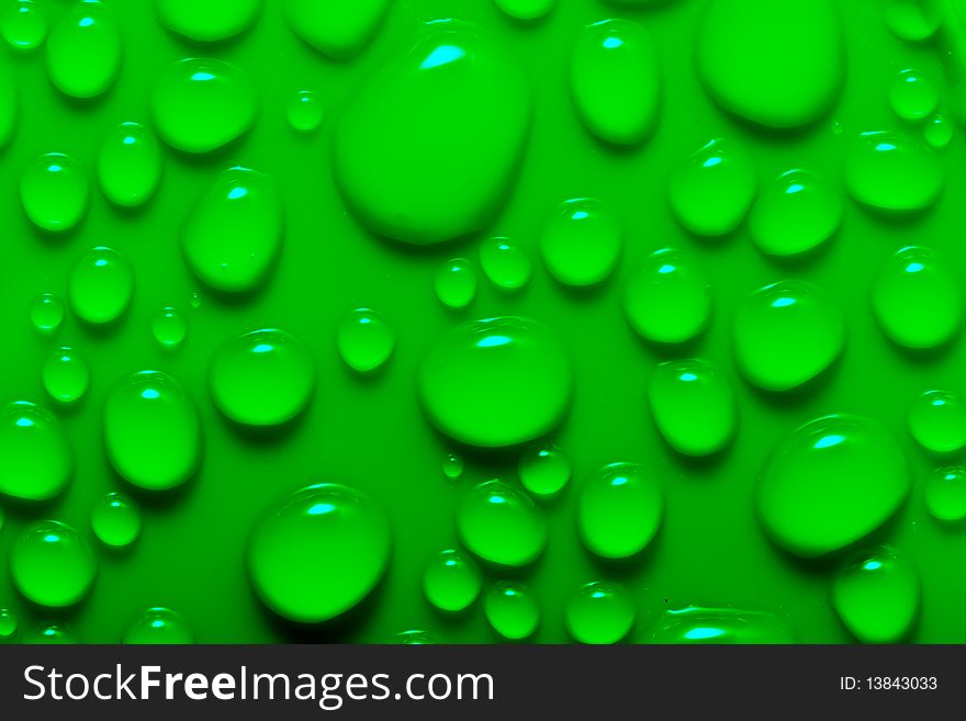 Water drops on a green surface