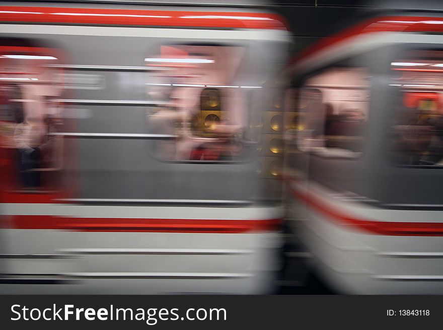 Blurred subway cars rushing through tunnel