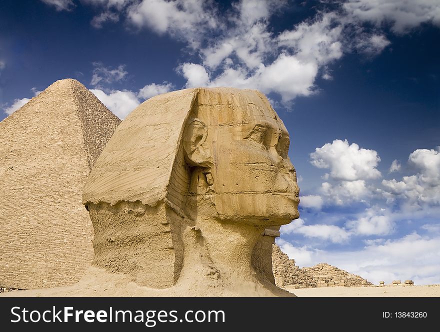 Ancient Egyptian Sphinx with old historic pyramid behind. Ancient Egyptian Sphinx with old historic pyramid behind