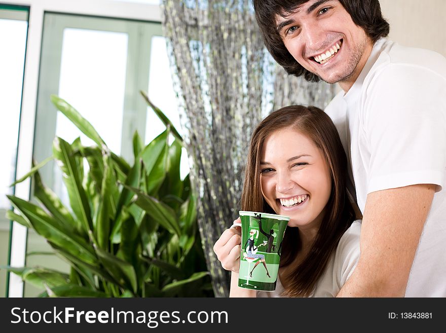 Girl with long hair and with cup and boy with smile