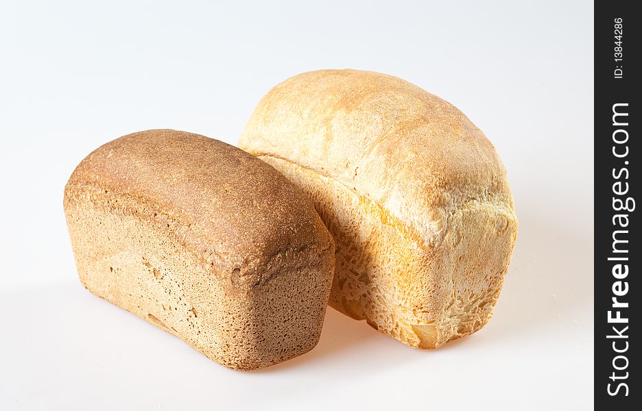 Loaf of bread with grains on a white background