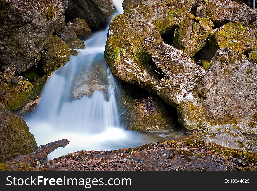Waterfall on a mountain creek between rocks. Waterfall on a mountain creek between rocks