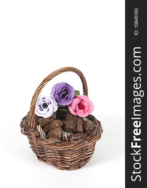 Dark brown basket filled with chocolate and roses