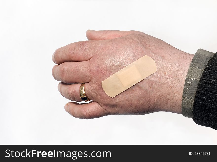 The medical adhesive plaster pasted on a hand of the man. The medical adhesive plaster pasted on a hand of the man
