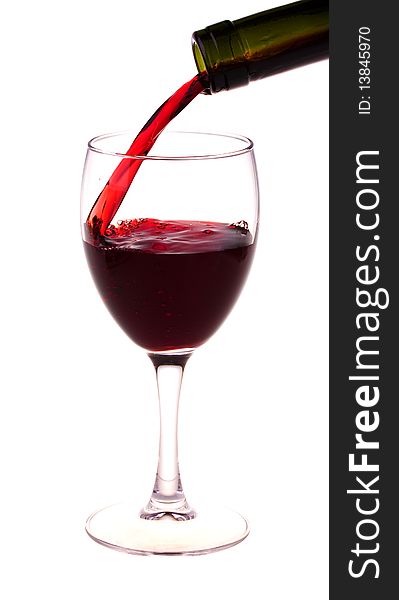 Red wine pouring from a wine bottle isolated on white background