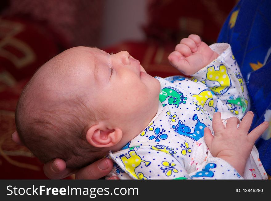 Photo of the sleeping baby on mother hands