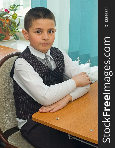 The pupil sits at a school desk. School