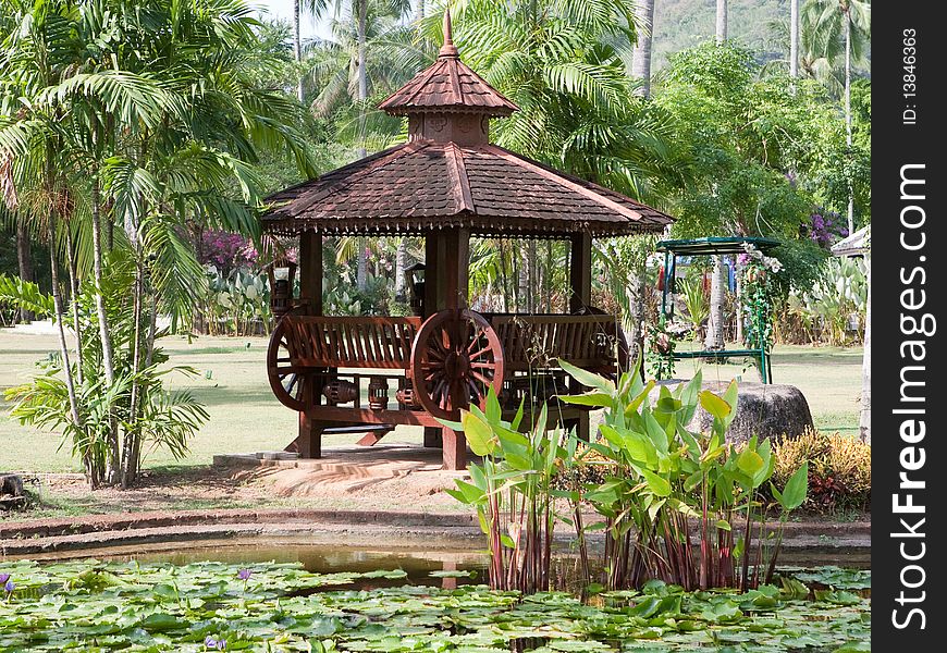 Wooden arbour and pond with flower
