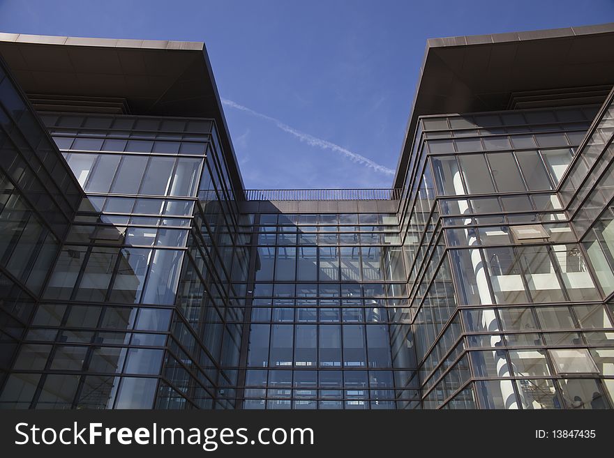 The modern office building on blue sky and white clouds background