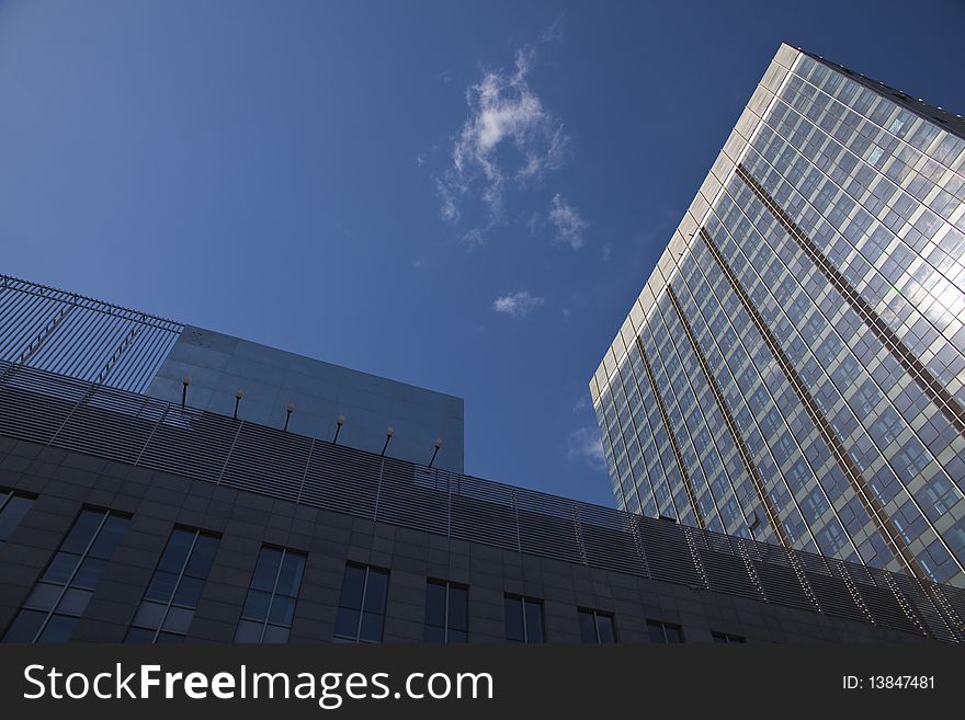 The modern office buildings on blue sky background. The modern office buildings on blue sky background