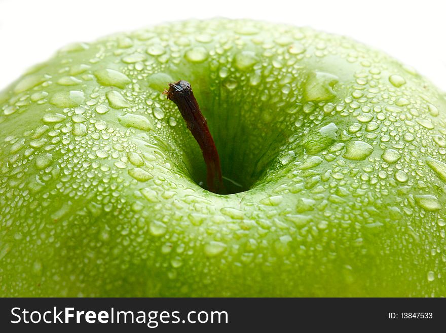 Water drops on ripe apple, macro closeup shot. Isolated over white.