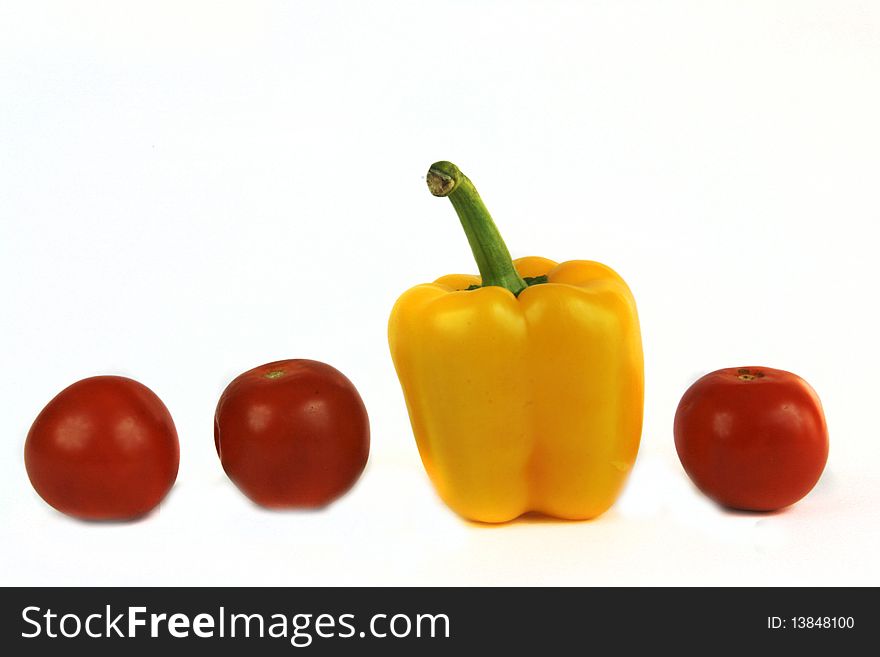 Yellow pepper and tomatoes isolated on white. Yellow pepper and tomatoes isolated on white