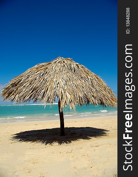 Parasol made out of palm leafs on exotic  beach. Dominican Republic, Punta Cana.