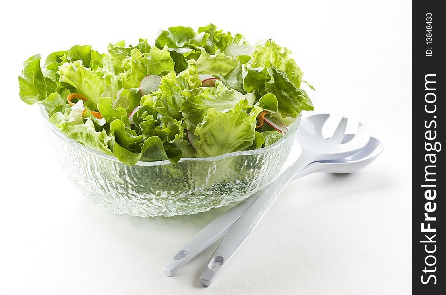 Fresh green salad in a bowl close up