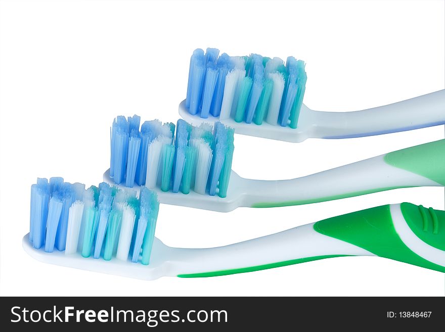 Three tooth-brushes it is isolated on a white background