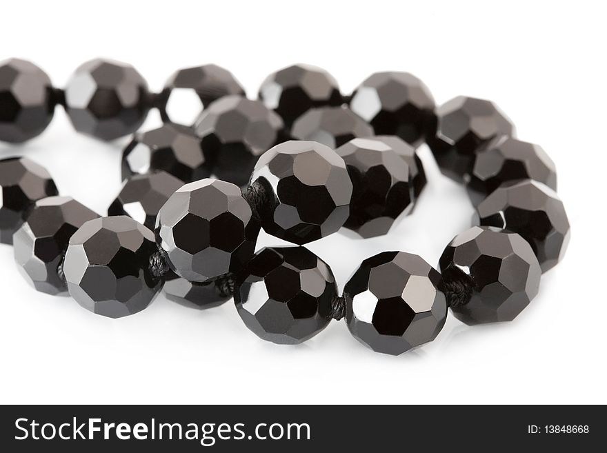 Black beads on white background