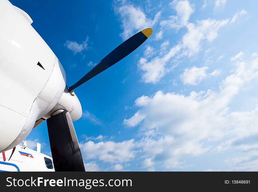 Black wings of an airplane motor in a blue sky