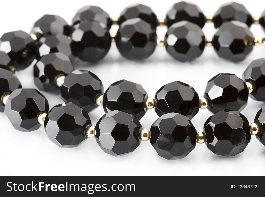 Black beads on white background